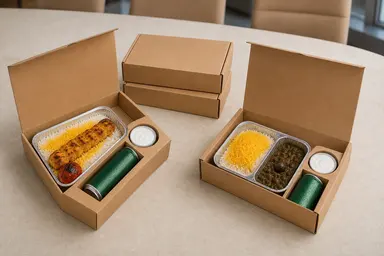 Four matching kraft Catering Toronto boxes arranged for an office delivery